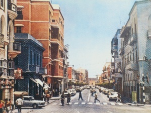 An old photo of a historic street in Benghazi, with the Omar Mukhtar shrine visible at the end.